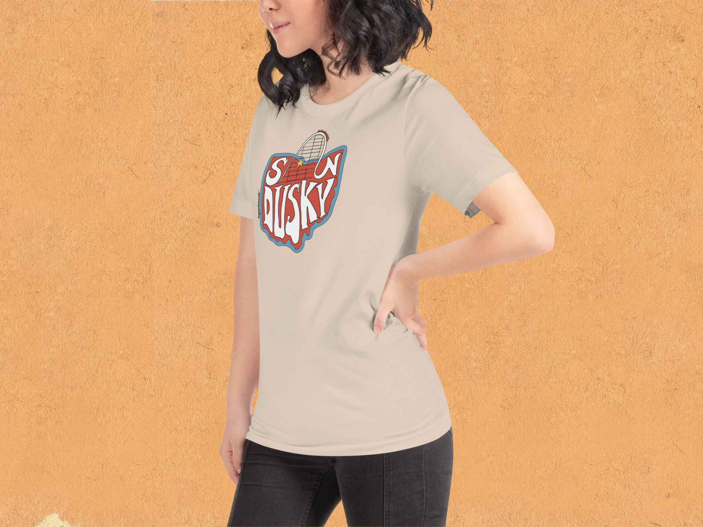 sandusky shirt, roller coaster shirts, front left, female model, orange textured background