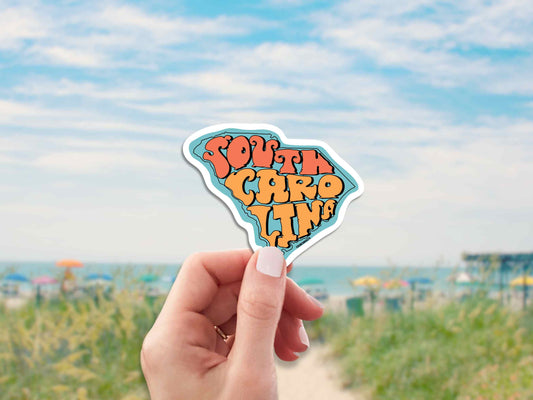 south carolina state travel luggage sticker, hand display, beach background