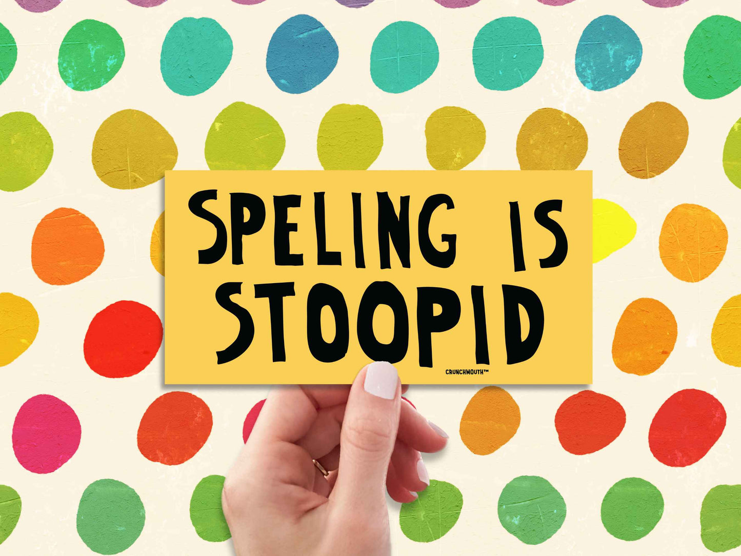 spelling is stupid funny bumper sticker, hand display, colorful marker stripes background