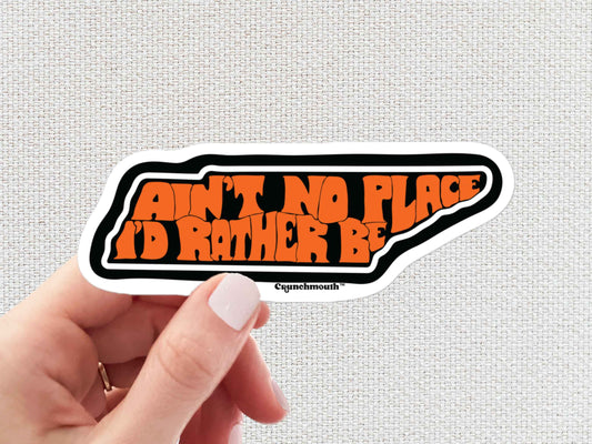 tennessee aint no place i'd rather be sticker, hand display, white textured background