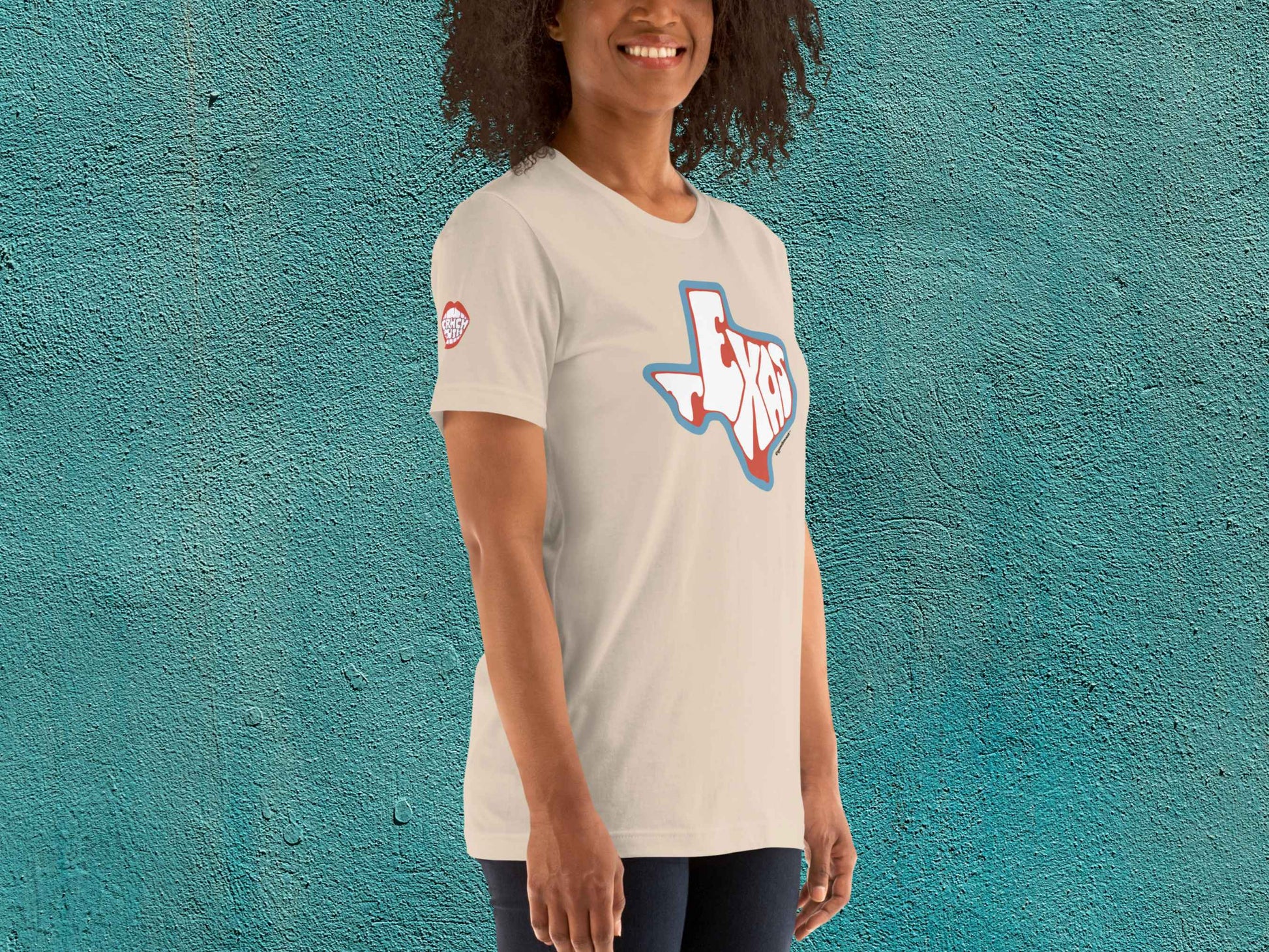 texas shirt, souvenir t shirts, female model, front right, teal textured background