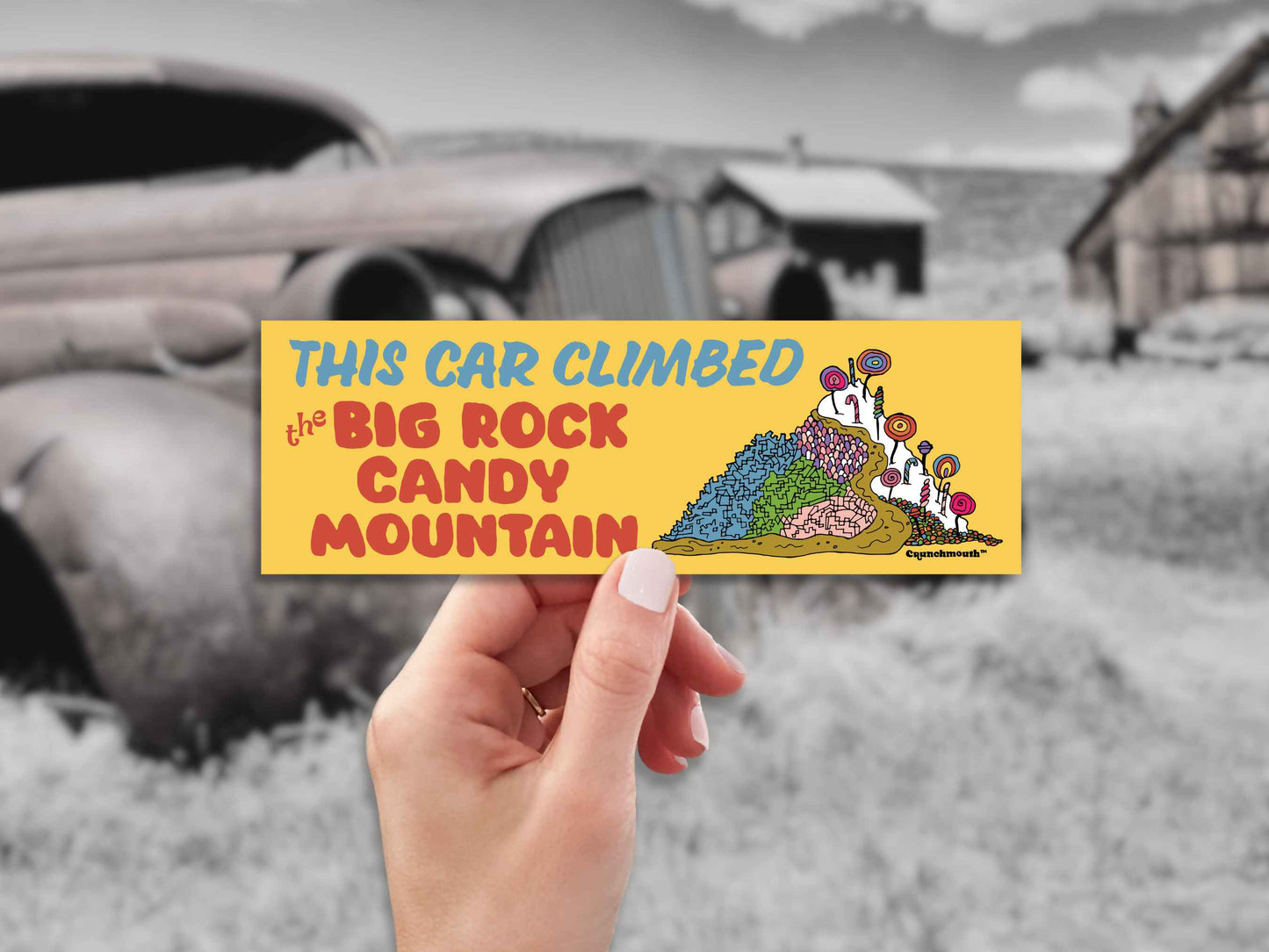 this car climbed the big rock candy mountain bumper sticker, hand display, rusty old car background