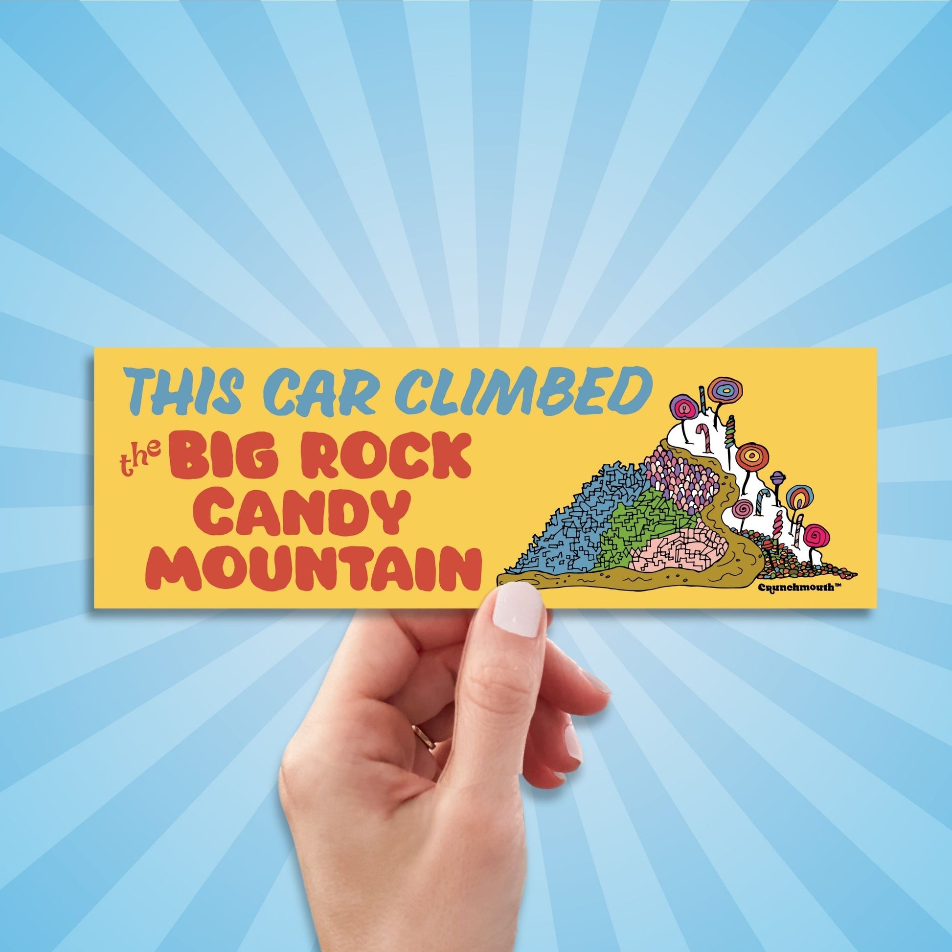 this car climbed the big rock candy mountain bumper sticker, hand display, sun rays pattern background