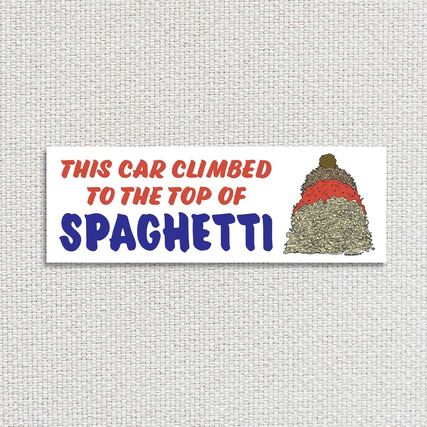 this car climbed to the top of spaghetti bumper sticker, textured fabric background
