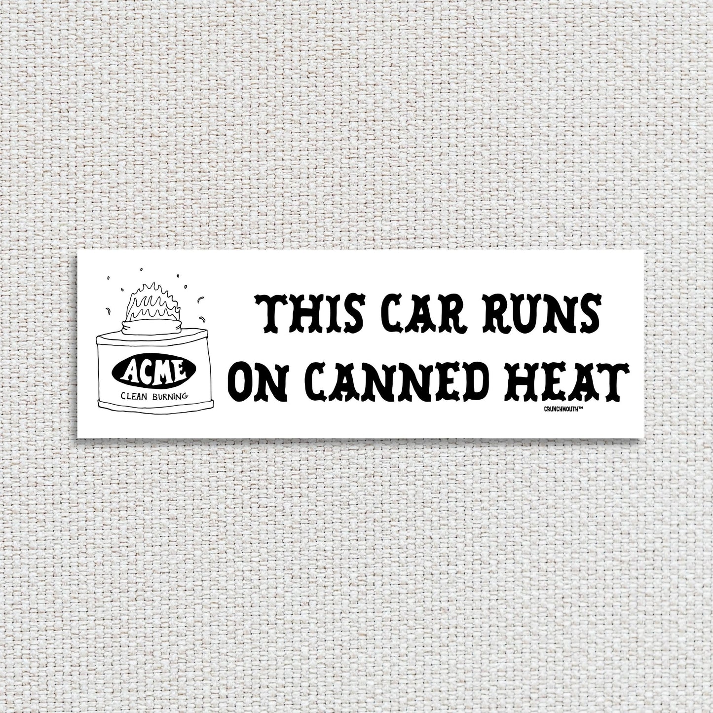 this car runs on canned heat bumper sticker, textured fabric background
