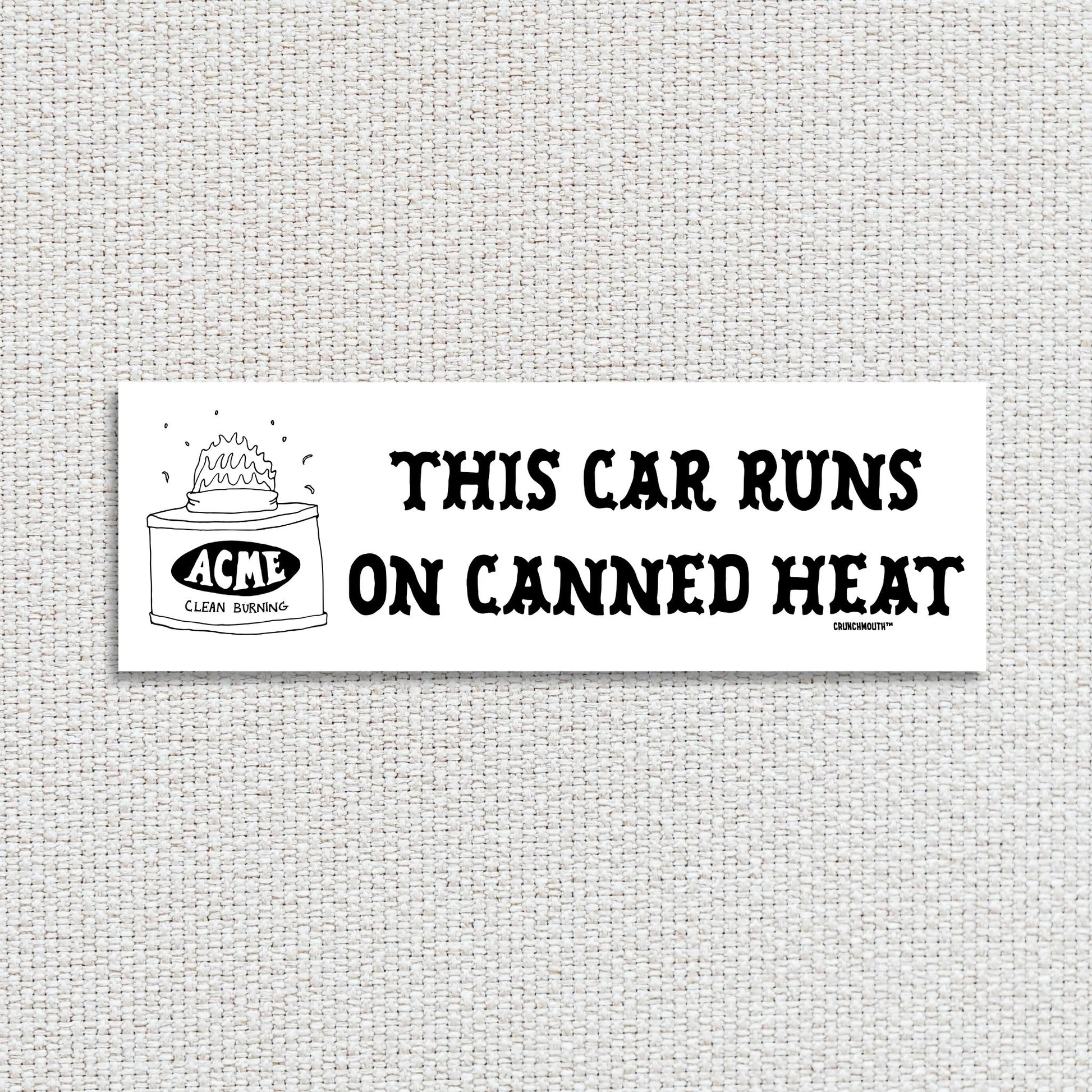 this car runs on canned heat bumper sticker, textured fabric background
