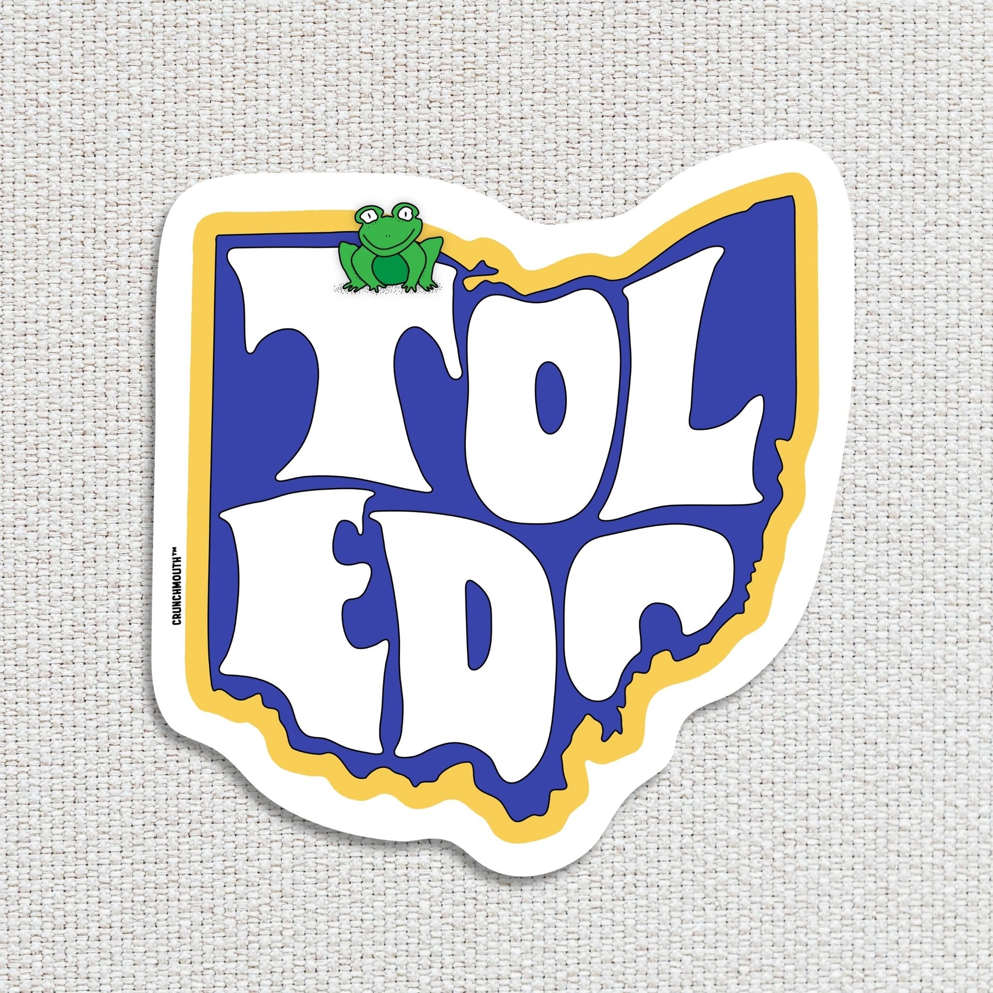 toledo travel luggage sticker, textured fabric background
