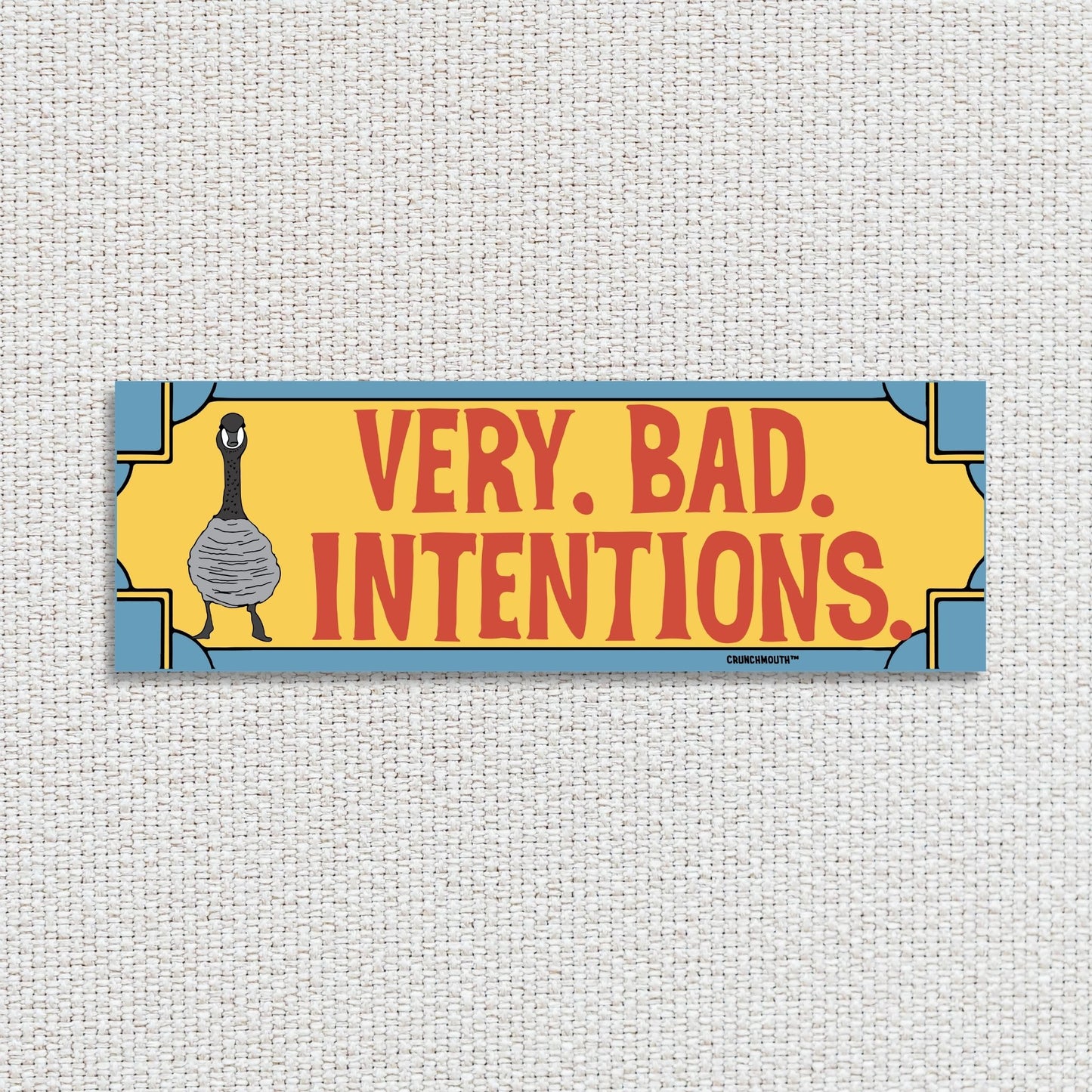 Canada goose bumper sticker, very bad intentions, textured fabric background
