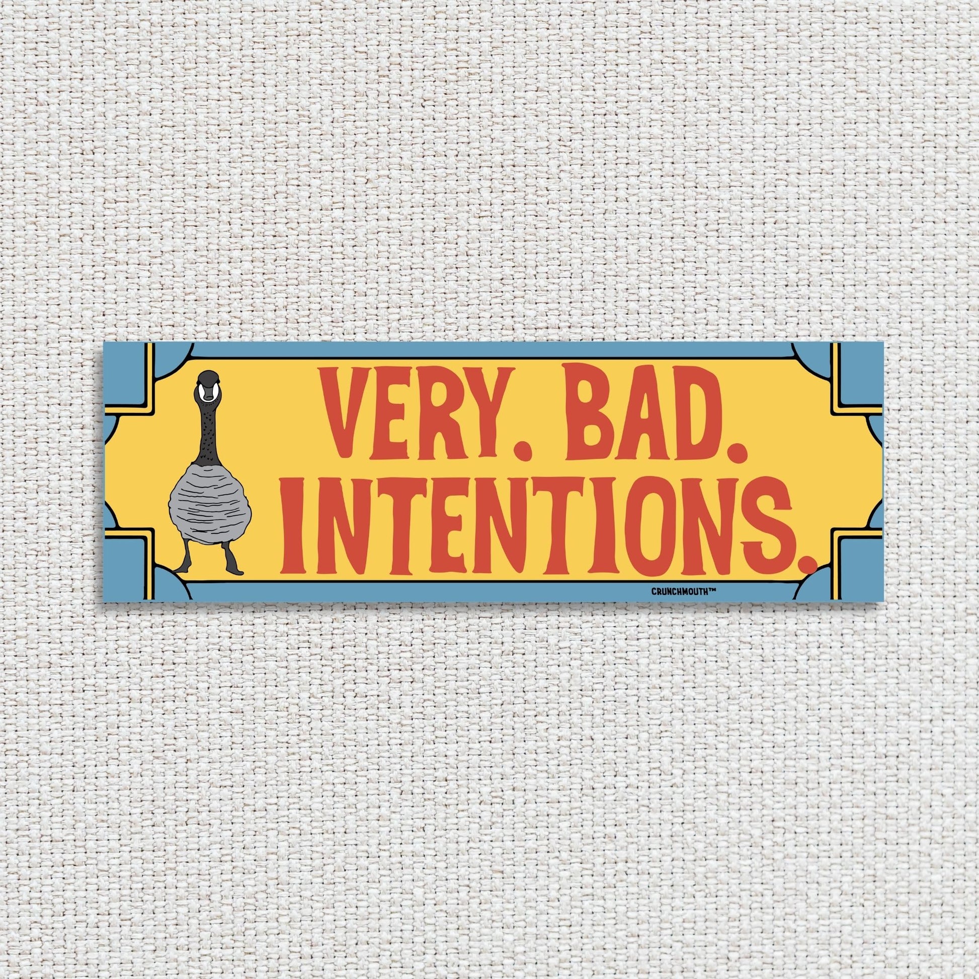 Canada goose bumper sticker, very bad intentions, textured fabric background
