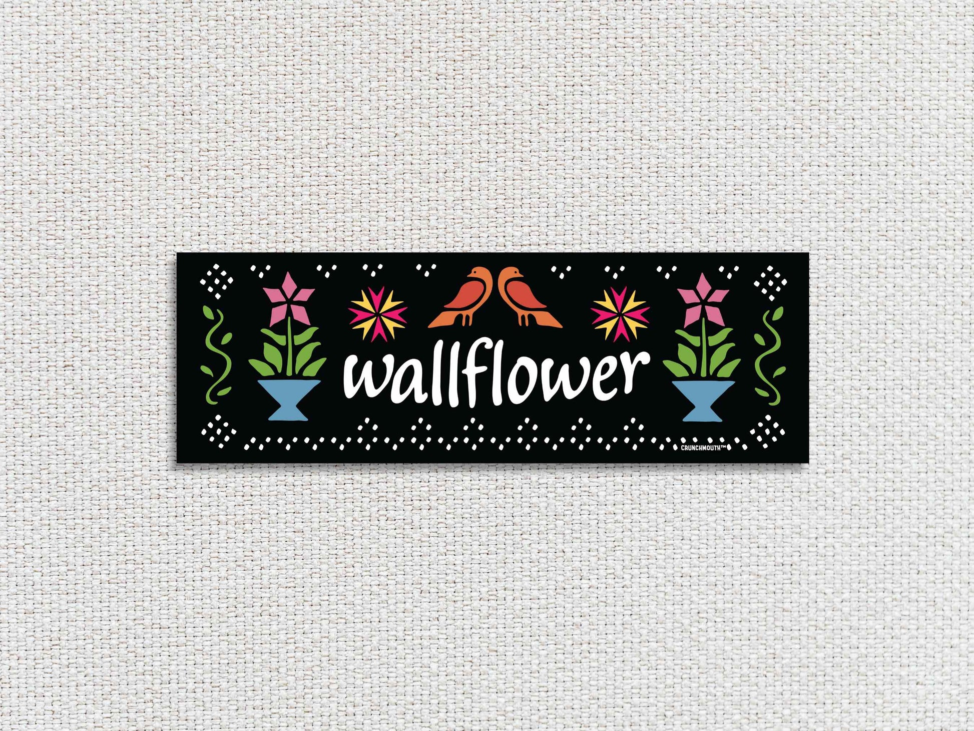 wallflower bumper sticker, hand display, white textured fabric background