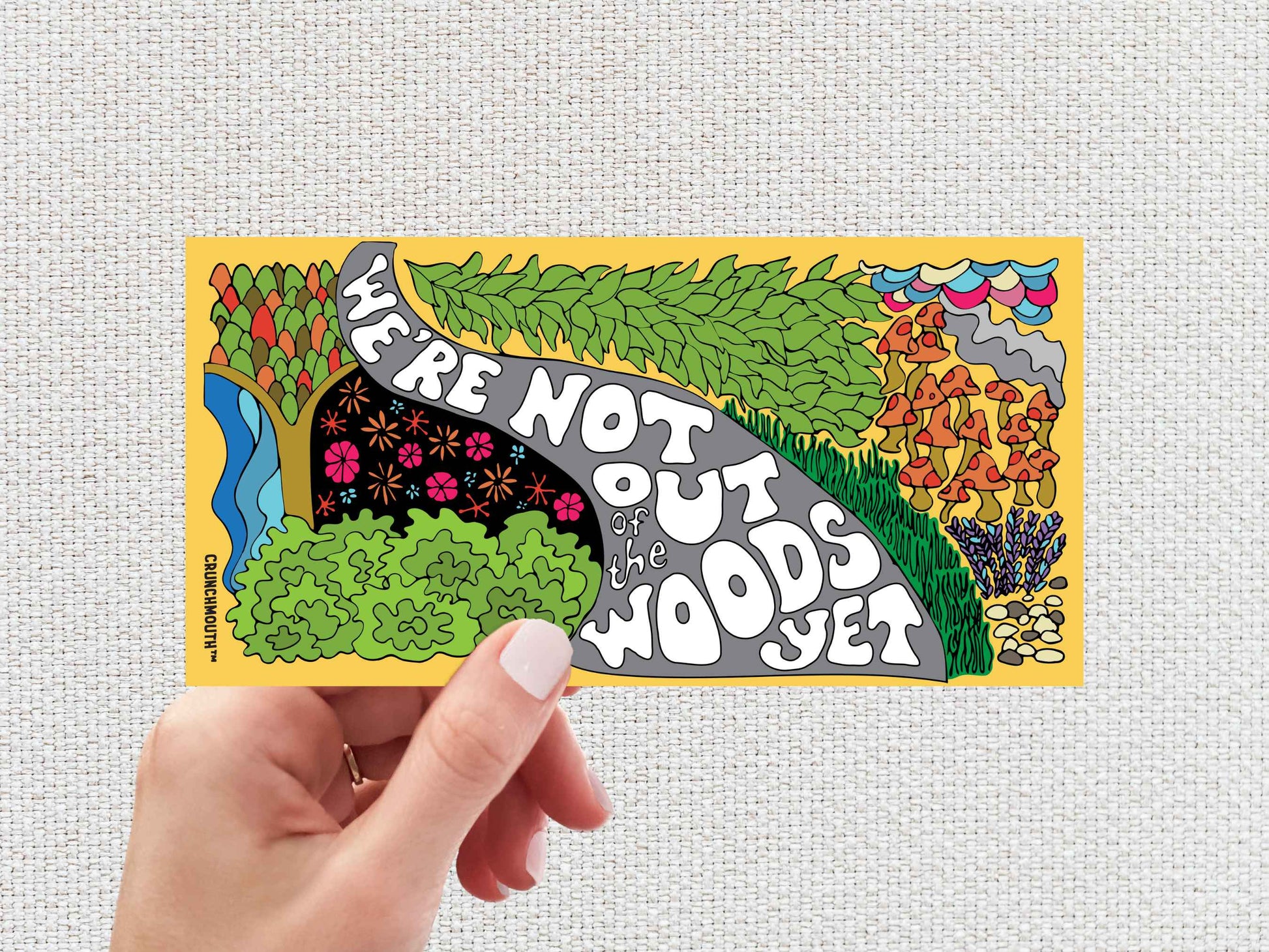 we&#39;re not out of the woods yet bumper sticker, hand display, white textured background
