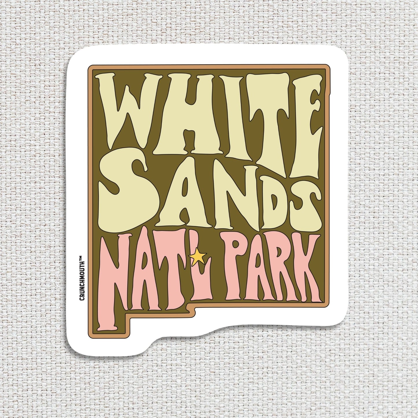 white sands national park travel luggage sticker, hand display, textured fabric background
