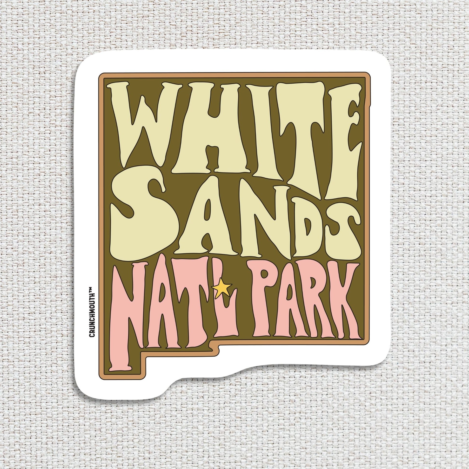 white sands national park travel luggage sticker, hand display, textured fabric background

