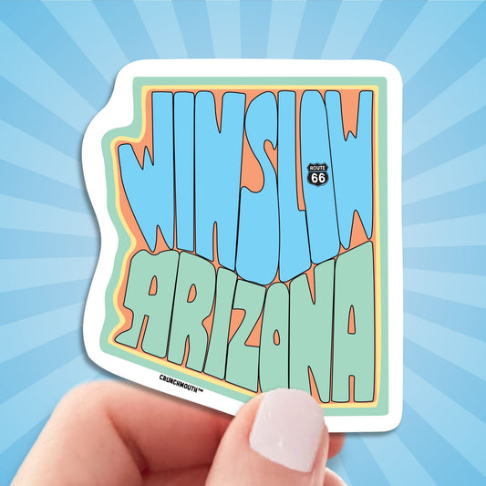 winslow Arizona travel luggage sticker, hand display, sun rays design background
