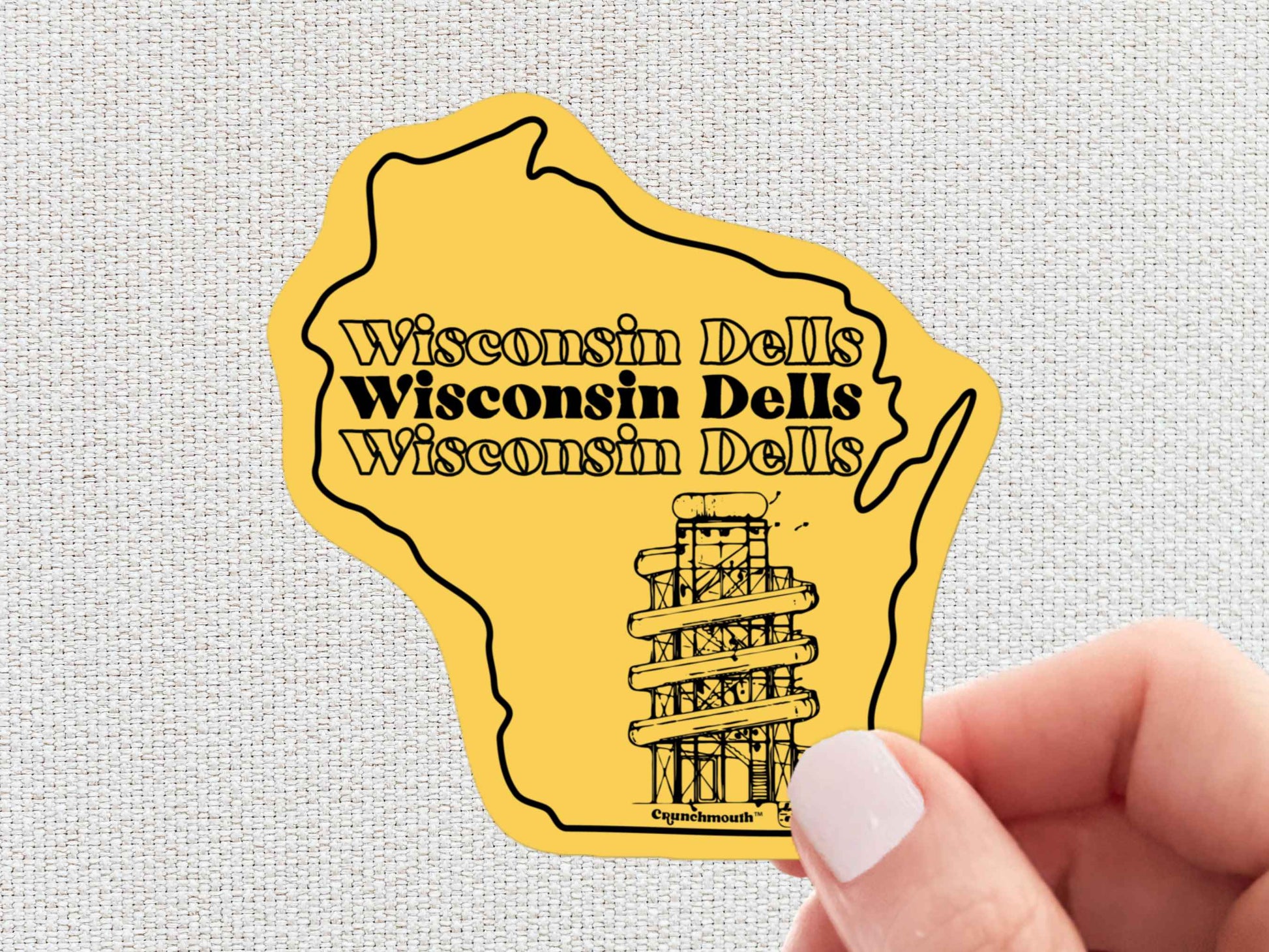 wisconsin dells sticker, hand display, white textured background